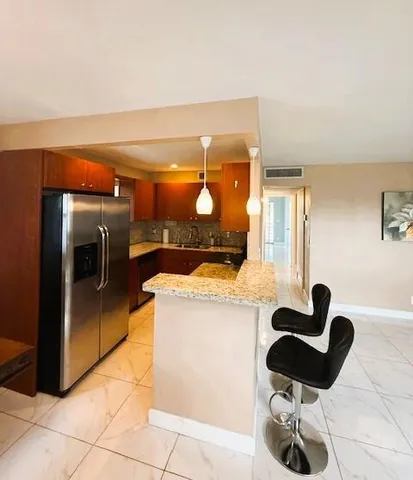 a kitchen with a sink a counter and cabinets