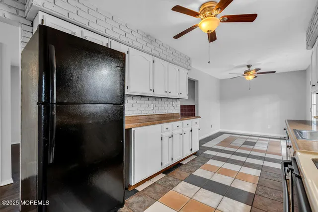 a kitchen with stainless steel appliances granite countertop a refrigerator a stove and a sink