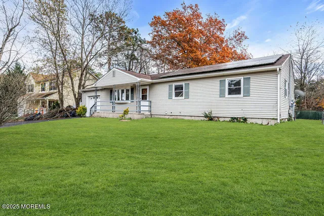 a front view of house with yard and green space