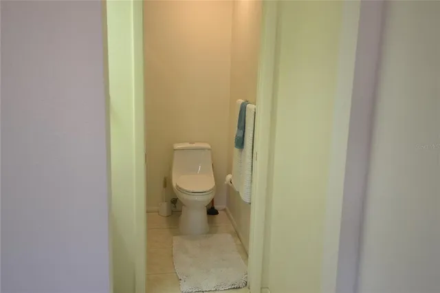a white toilet sitting next to a white wall