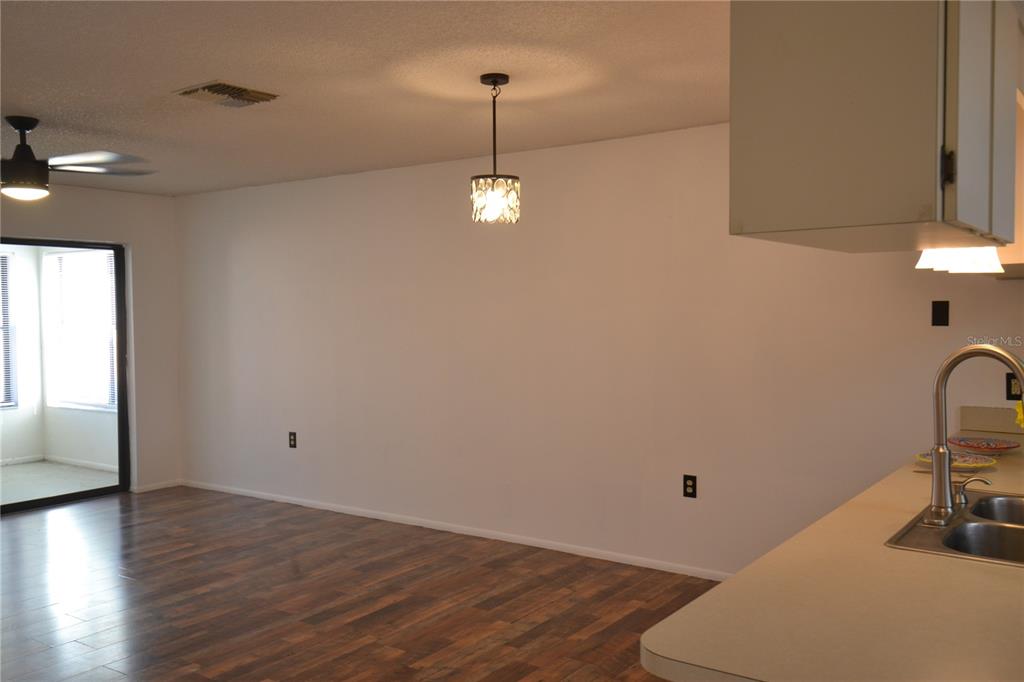 7331 Greystone Drive Hudson, FL 34667 - Photo 18 of 39 a room with a table and a chair