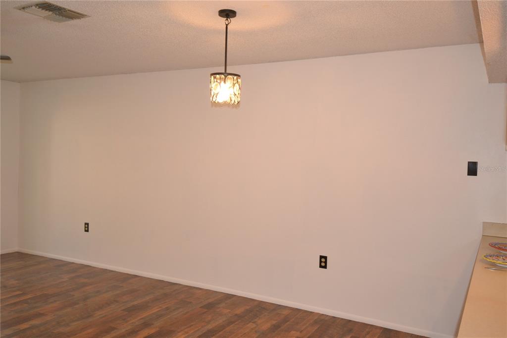 7331 Greystone Drive Hudson, FL 34667 - Photo 20 of 39 a view of a room with a wooden floor and window