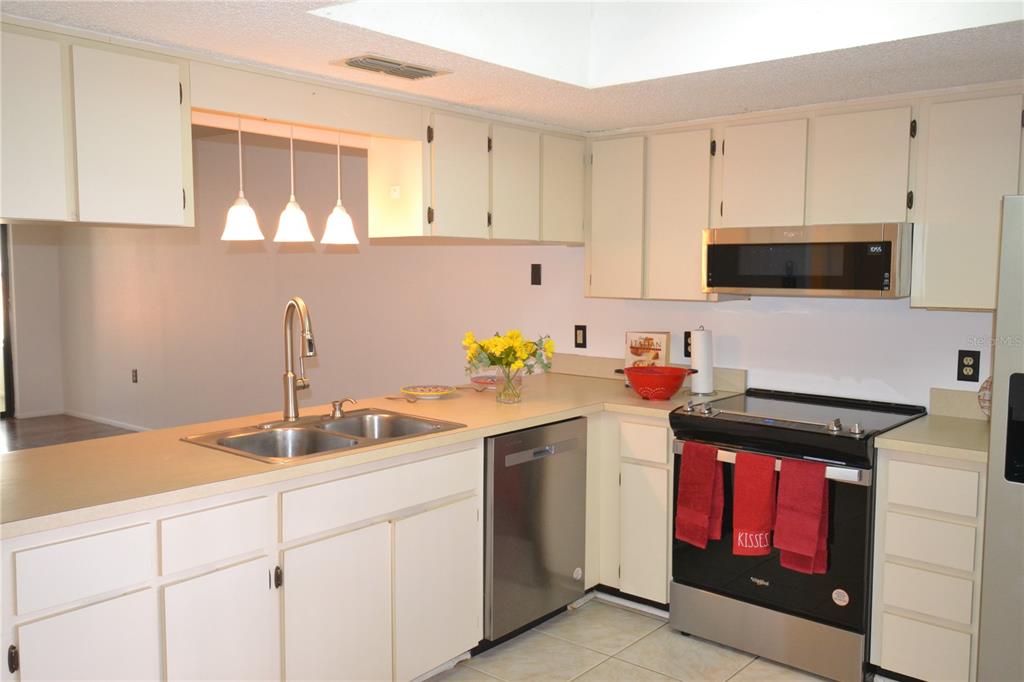 7331 Greystone Drive Hudson, FL 34667 - Photo 2 of 39 a kitchen with stainless steel appliances granite countertop a sink and a stove
