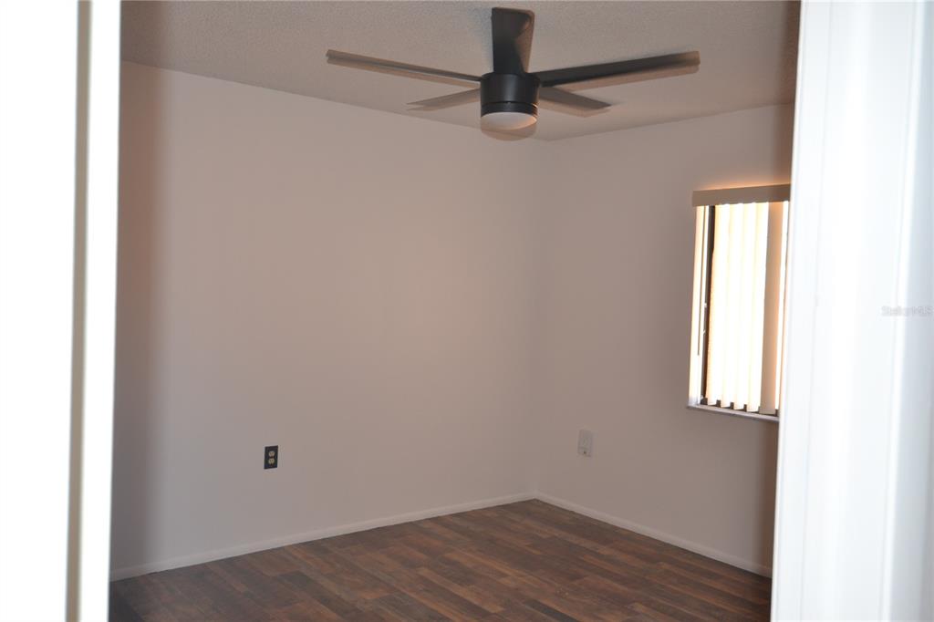 7331 Greystone Drive Hudson, FL 34667 - Photo 21 of 39 a view of a small space with wooden floor and a window