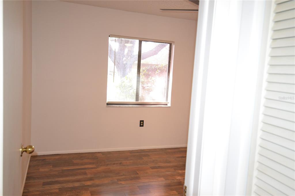 7331 Greystone Drive Hudson, FL 34667 - Photo 30 of 39 a view of an empty room with wooden floor and a window