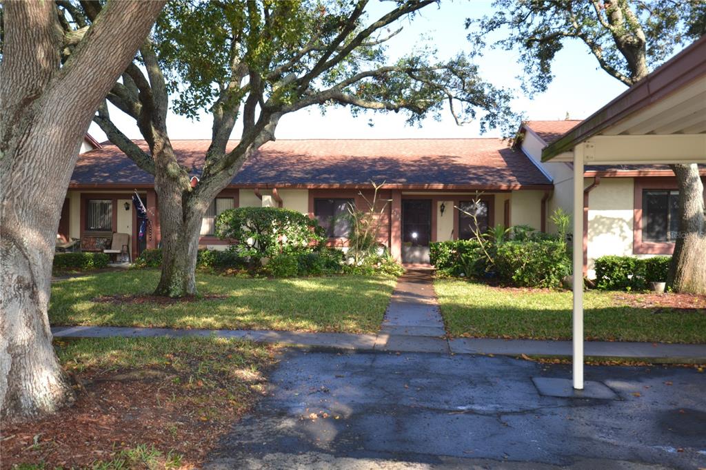 7331 Greystone Drive Hudson, FL 34667 - Photo 37 of 39 a front view of a house with garden