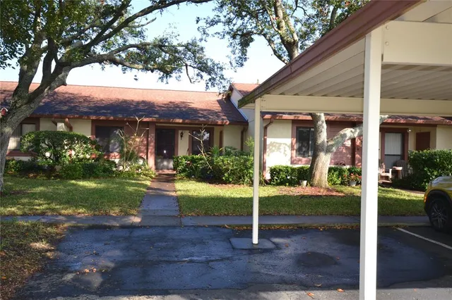 a front view of house with porch and garden