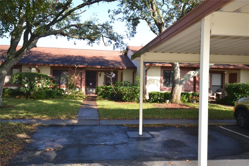7331 Greystone Drive Hudson, FL 34667 - Photo 38 of 39 a front view of house with porch and garden