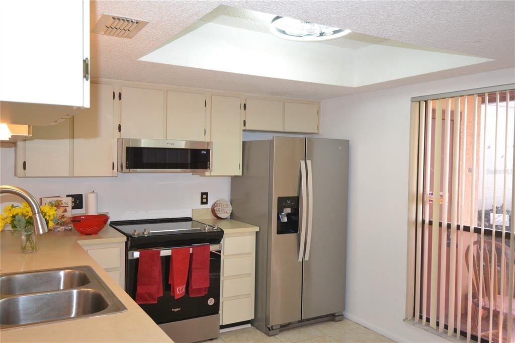 7331 Greystone Drive Hudson, FL 34667 - Photo 4 of 39 a kitchen with stainless steel appliances granite countertop a refrigerator and a sink