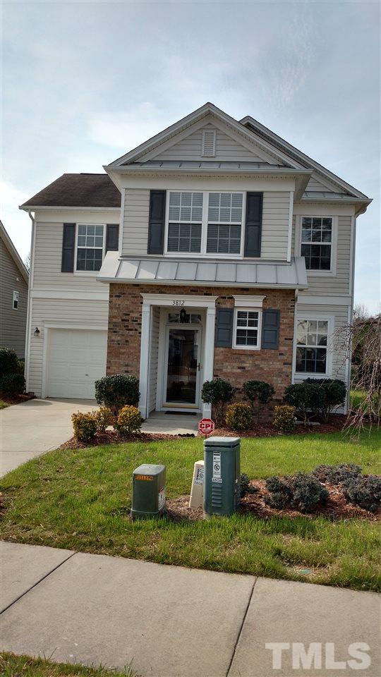 3812 Tryon Ridge Drive Raleigh, NC 27610 - Photo 22 of 23 a front view of a house with a yard and garage