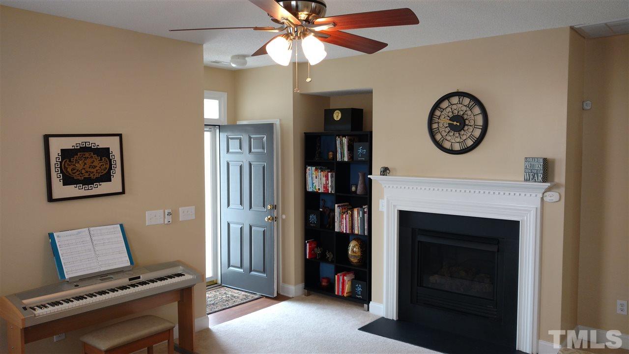 3812 Tryon Ridge Drive Raleigh, NC 27610 - Photo 4 of 23 a view of a hallway with a fireplace and a bookshelf