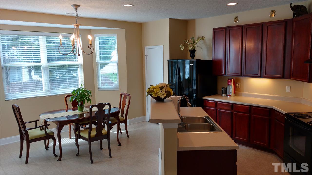 3812 Tryon Ridge Drive Raleigh, NC 27610 - Photo 8 of 23 a kitchen with a table chairs and refrigerator