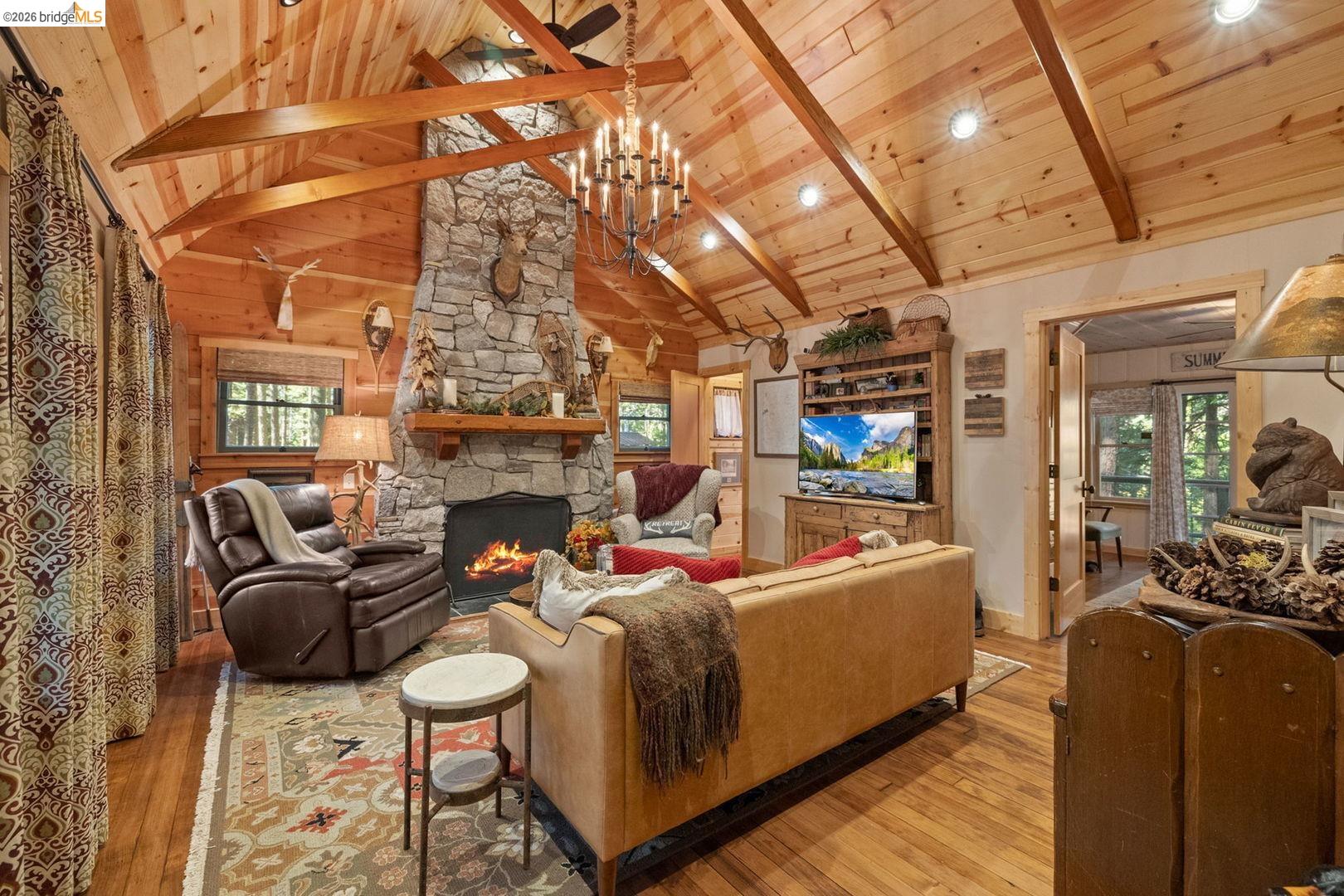 a living room with furniture a fireplace and a table