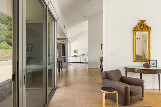 a living room filled with furniture and a window