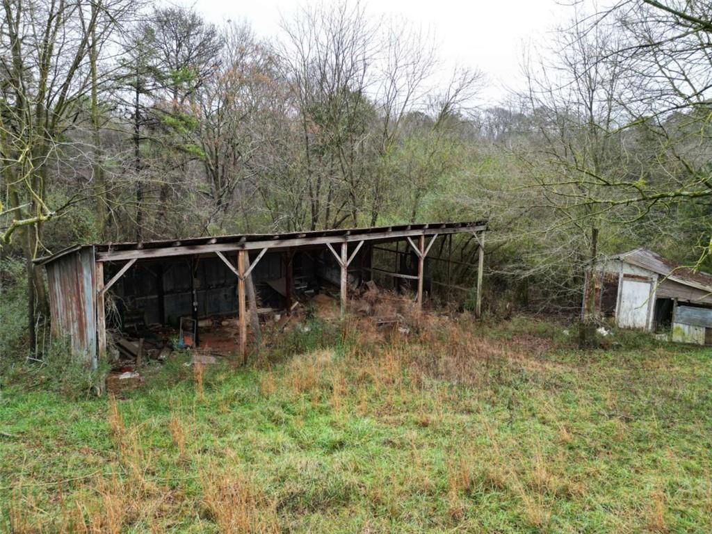 6050 Sandy Cross Road Carnesville, GA 30521 - Photo 4 of 5 a backyard of a house with table and chairs