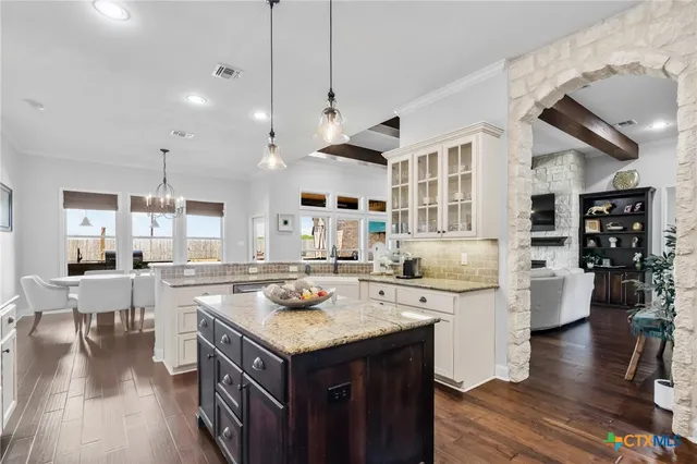 a kitchen with a sink stove and cabinets