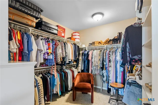 a bathroom with a granite countertop sink a toilet and a mirror