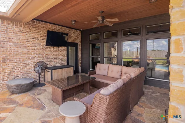 a view of a swimming pool with an outdoor seating and a yard