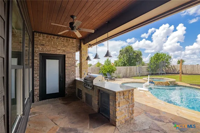 a view of a swimming pool with a patio