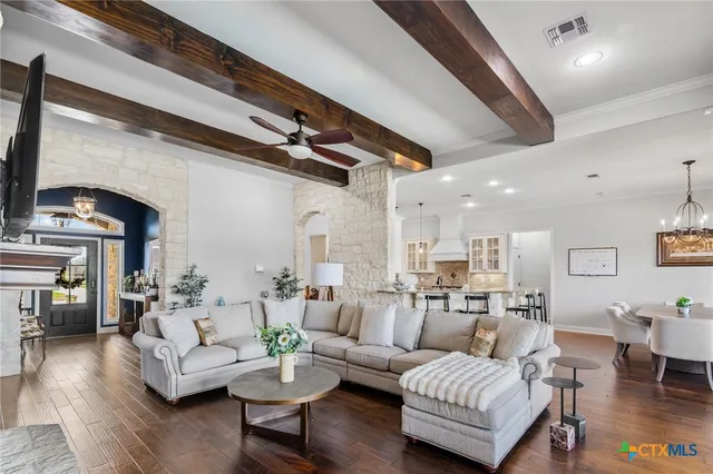 a living room with fireplace furniture and a flat screen tv