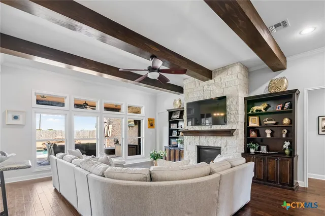 a dining room with furniture a chandelier and wooden floor