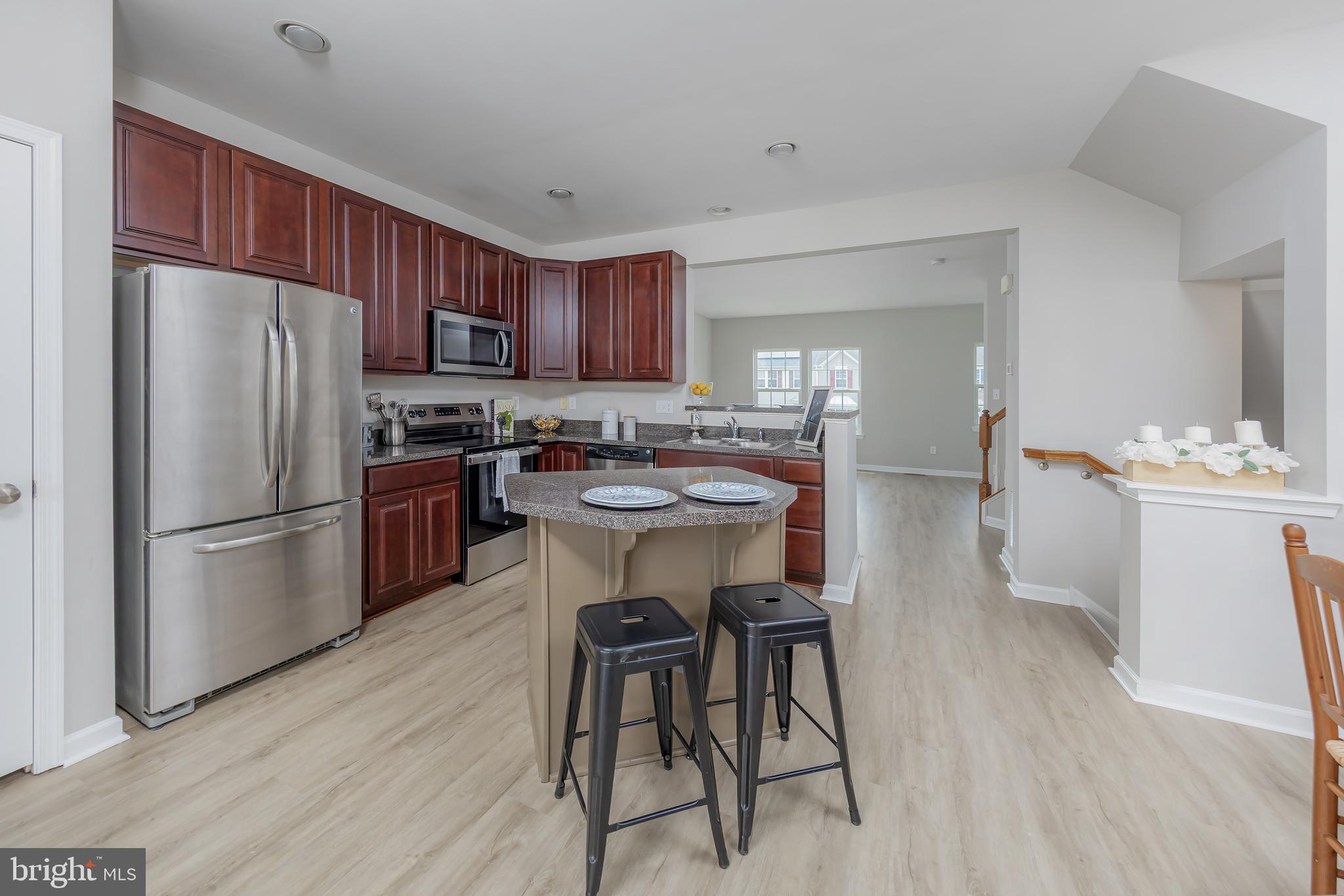 371 Concetta Drive Mount Royal, NJ 08061 - Photo 11 of 20 a kitchen with stainless steel appliances a refrigerator a stove a sink a table and chairs