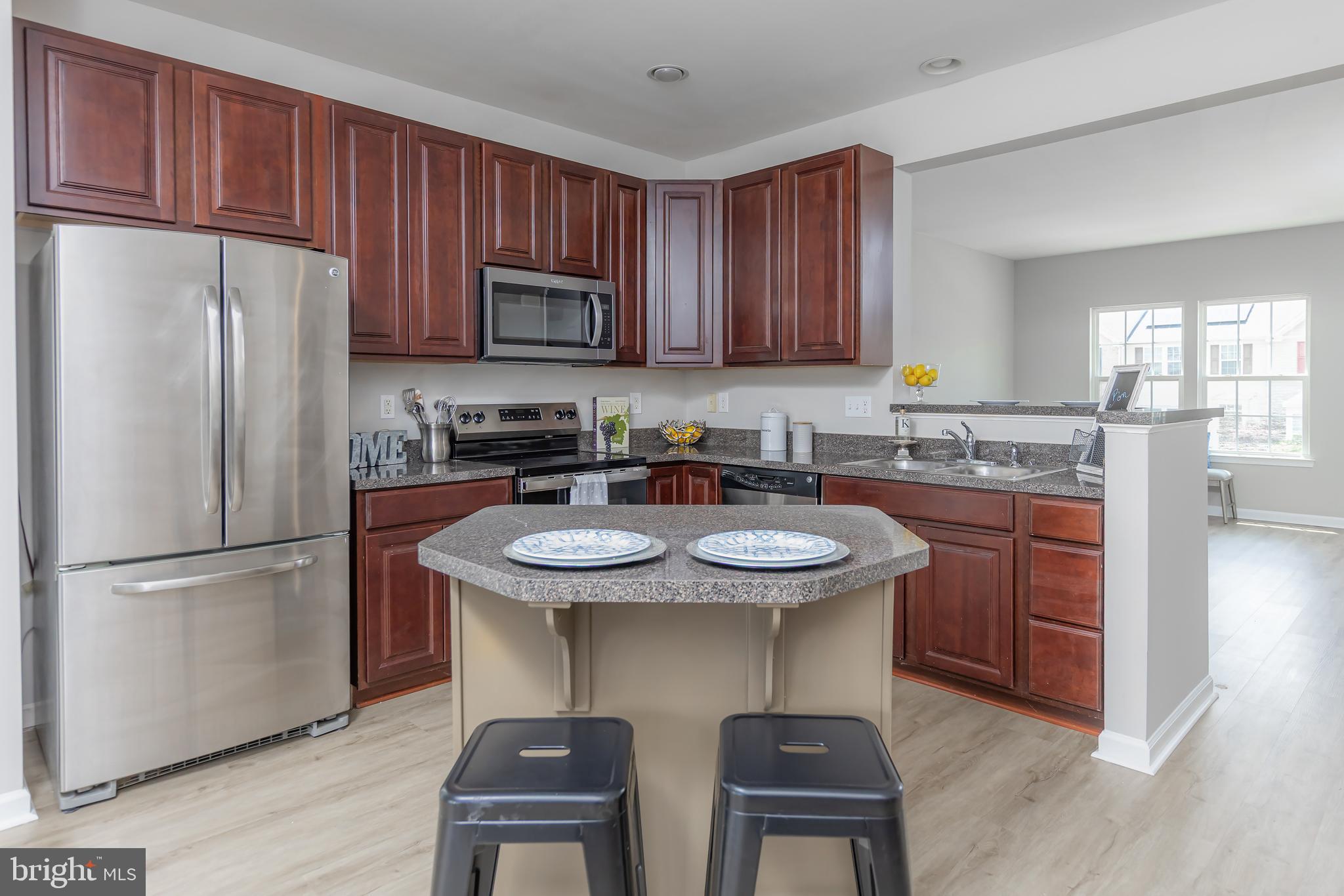 371 Concetta Drive Mount Royal, NJ 08061 - Photo 9 of 20 a kitchen with stainless steel appliances granite countertop a sink a stove a refrigerator and cabinets