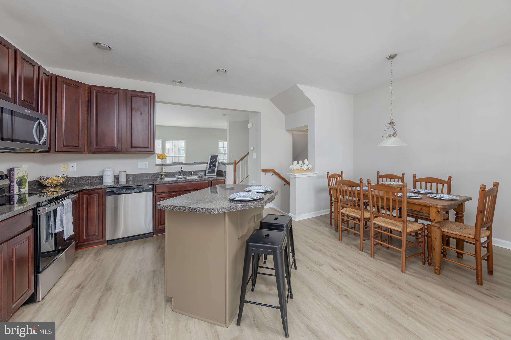 371 Concetta Drive Mount Royal, NJ 08061 - Photo 10 of 20 a kitchen with a dining table chairs and wooden floor