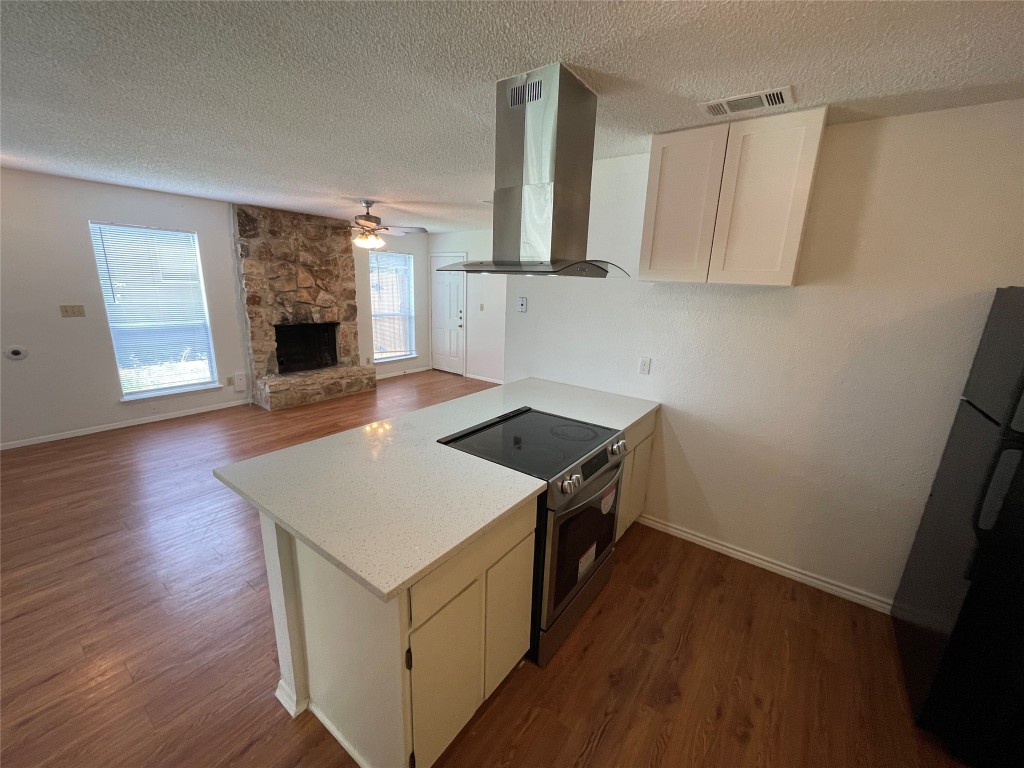 7506 St Amant Place, Unit B Austin, TX 78749 - Photo 15 of 16 a kitchen with wooden floor and a stove top oven