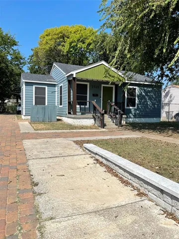 a backyard of a house with yard and barbeque oven