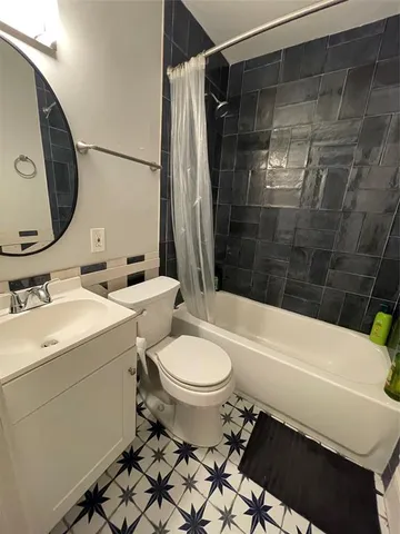 a kitchen with stainless steel appliances granite countertop a stove a sink dishwasher a refrigerator and white cabinets with wooden floor