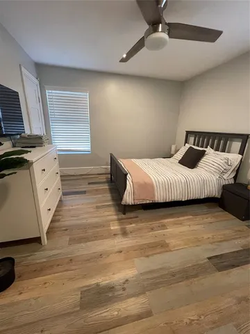 a large bedroom with a bed and a large window