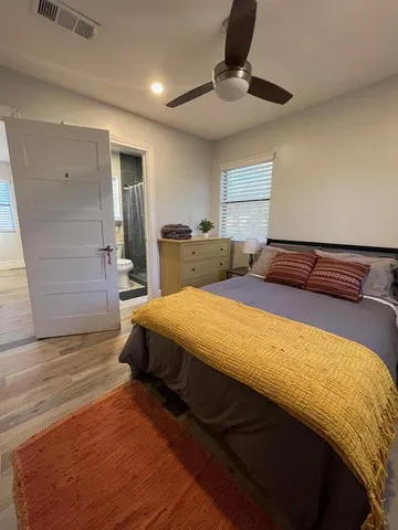a bedroom with a bed a desk and chair