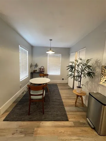 a living room with furniture rug and a window