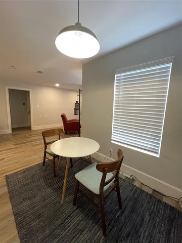 a workspace with furniture window and wooden floor