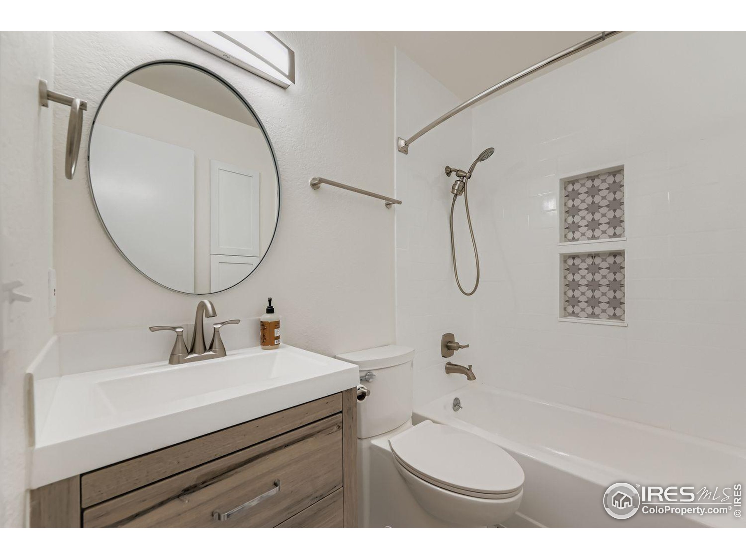 3565 28th Street, Unit 201 Boulder, CO 80301 - Photo 11 of 13 a bathroom with a sink a toilet and a mirror