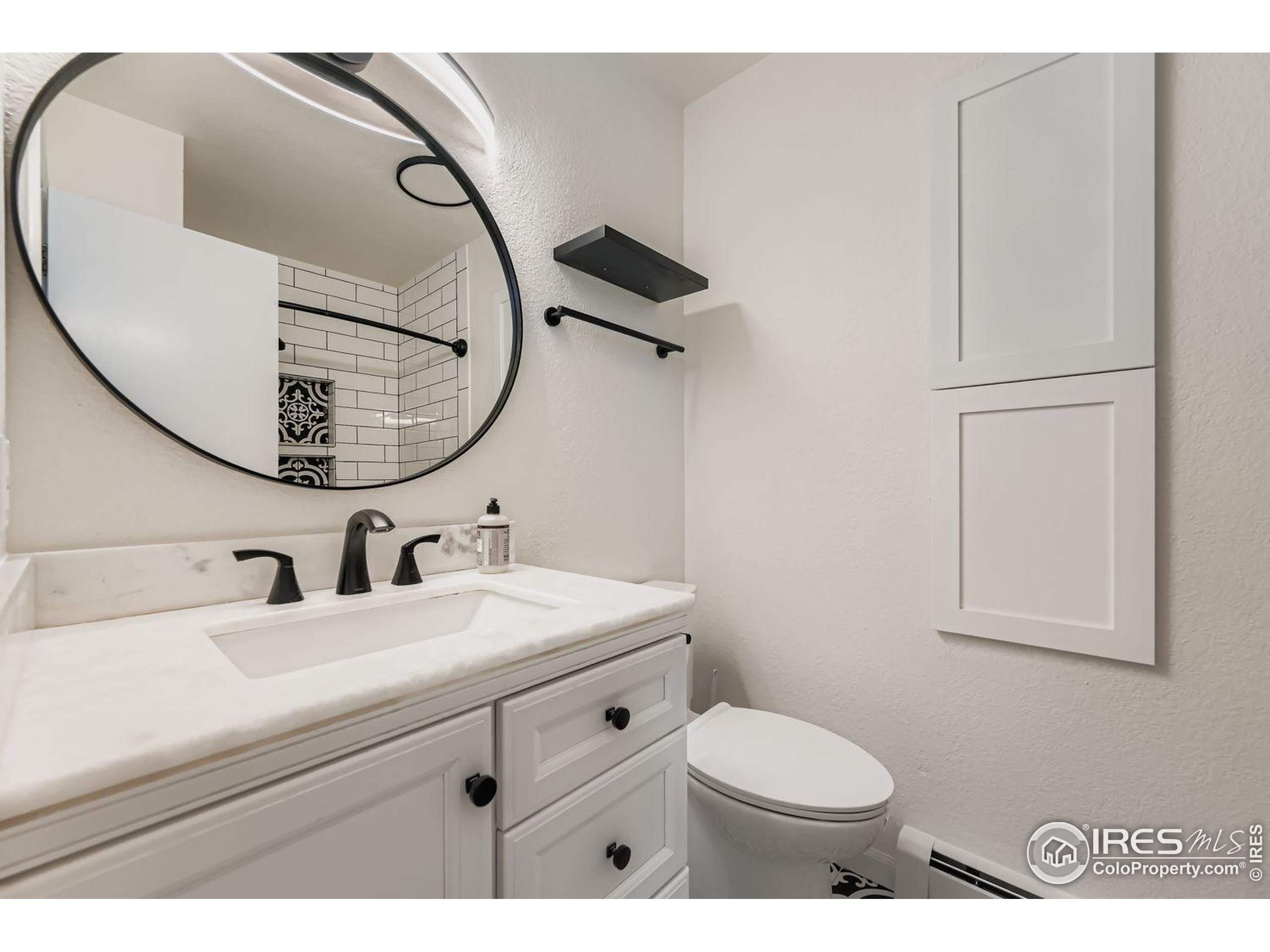 3565 28th Street, Unit 201 Boulder, CO 80301 - Photo 9 of 13 a bathroom with a sink mirror and toilet