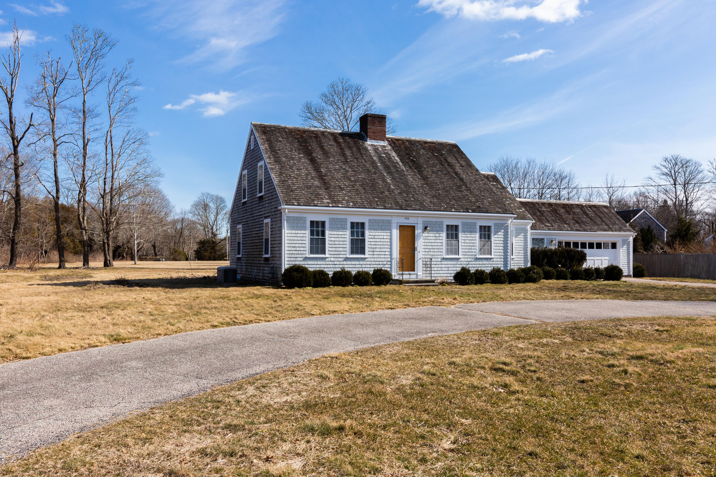 700 Main Street Cotuit, MA 02635 - Photo 2 of 20 a front view of house with yard and trees