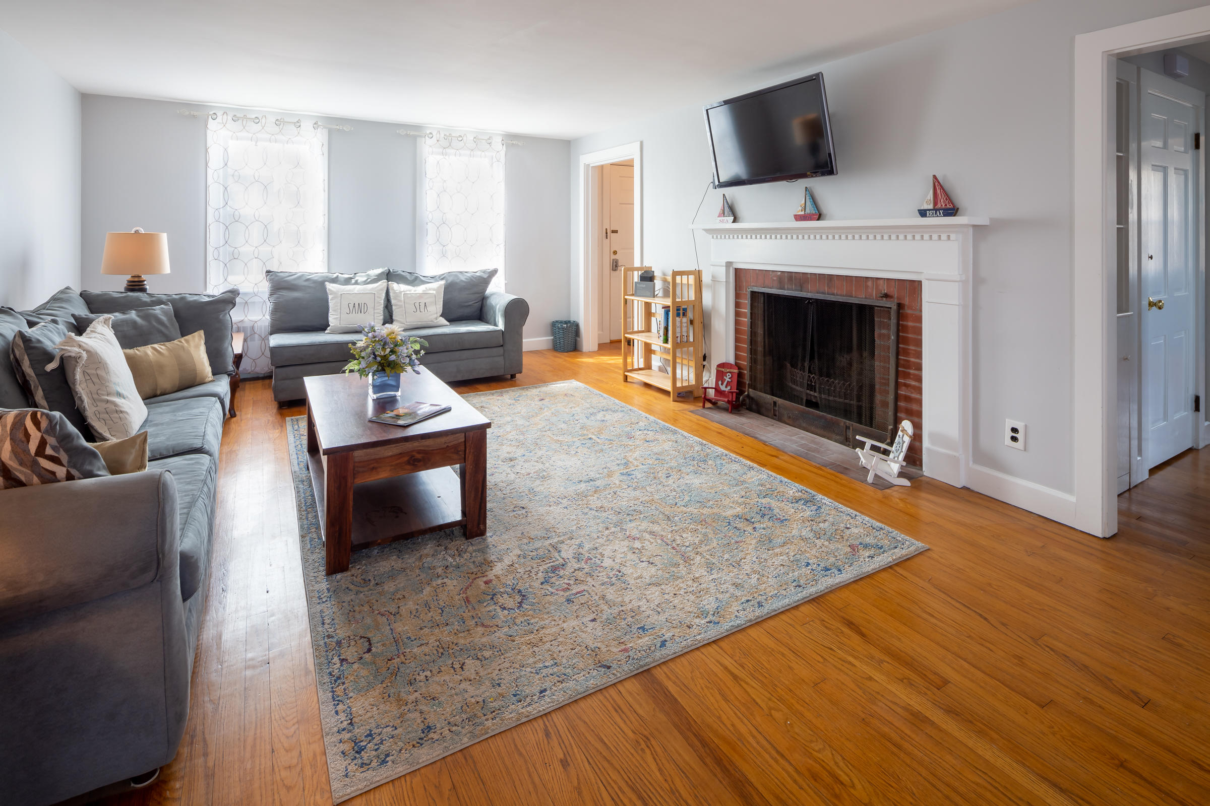 700 Main Street Cotuit, MA 02635 - Photo 4 of 20 a living room with furniture and a fireplace