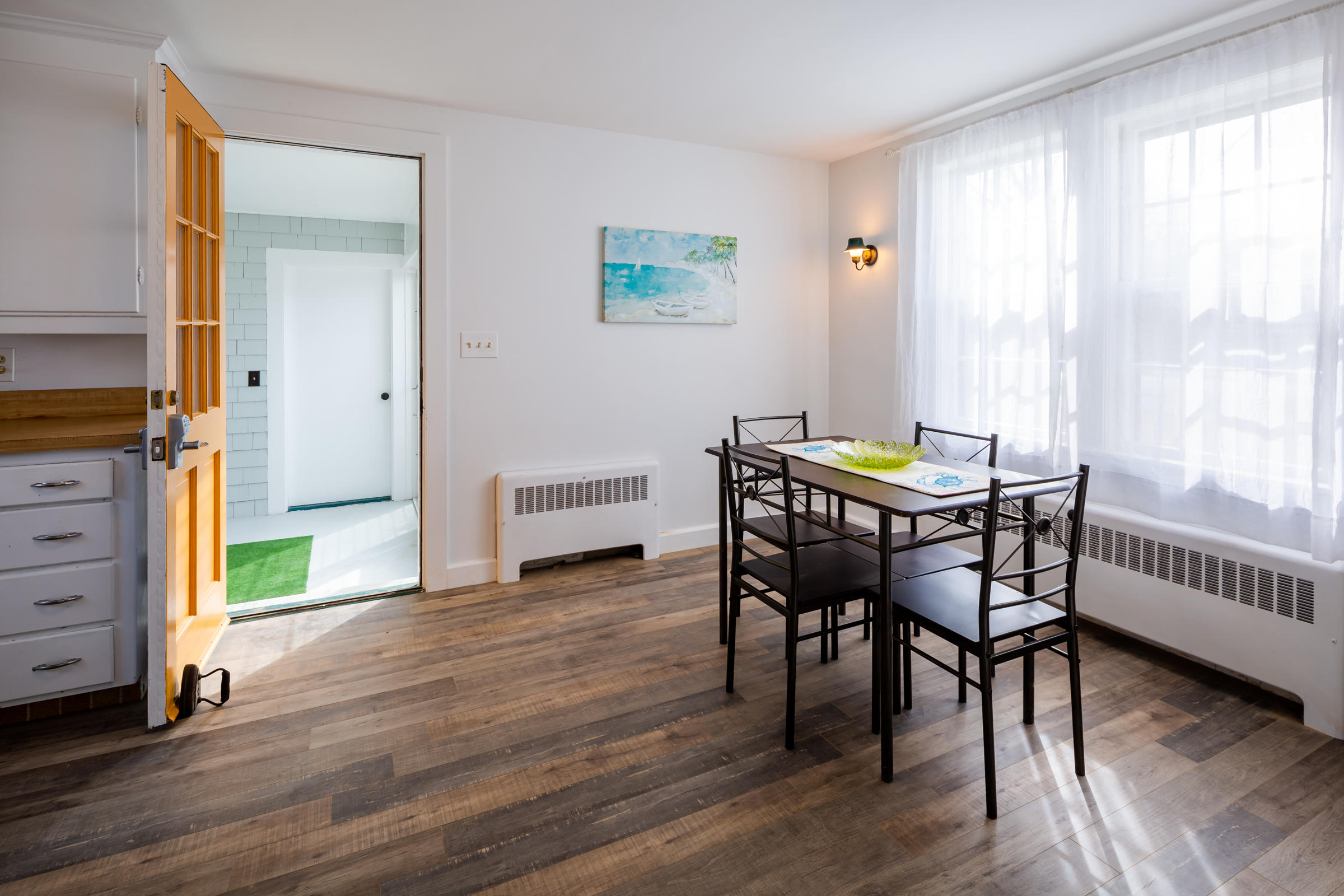 700 Main Street Cotuit, MA 02635 - Photo 8 of 20 a view of a dining room with furniture and window