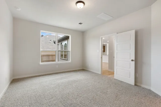 an empty room with windows and closet