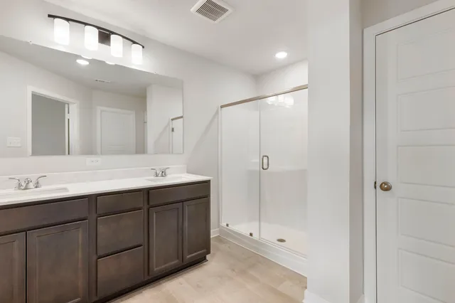 a bathroom with a double vanity sink and mirror