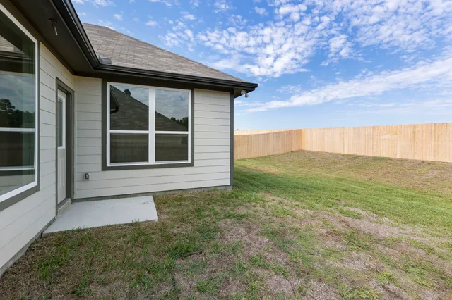 a backyard of a house with lots of green space