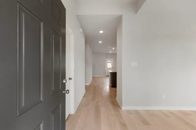 a view of a hallway with wooden floor