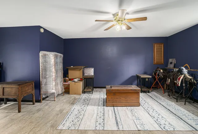 a bed room with a bed and a chair