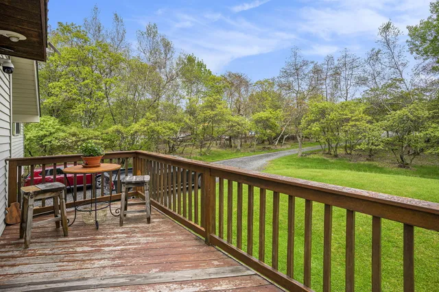 a view of a two chairs with table in the balcony