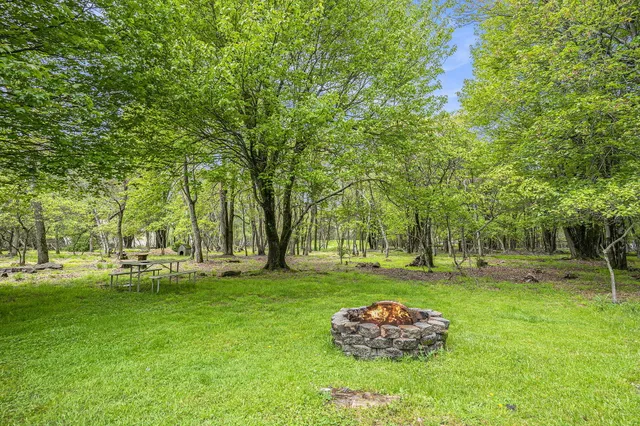 a backyard of a house with a table and chairs