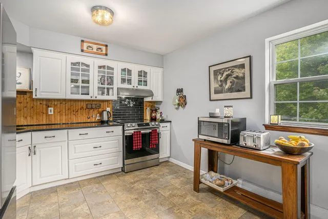 a kitchen with stainless steel appliances granite countertop a stove and a sink