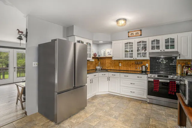 a kitchen with granite countertop a refrigerator and a stove