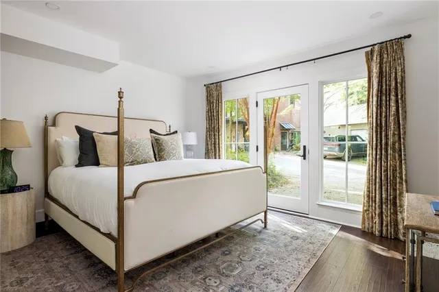 a bedroom with a bed and large window